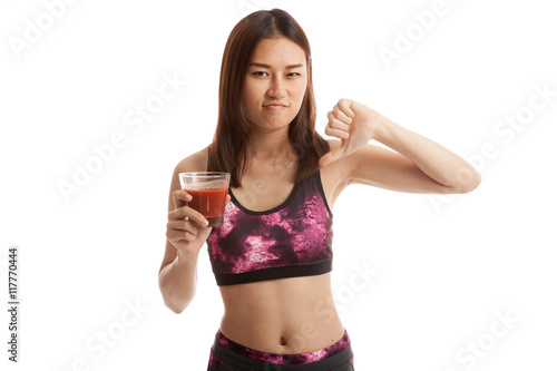 Beautiful healthy Asian girl hate tomato juice thumbs down. © halfbottle