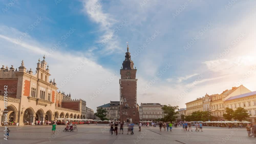 Market place, the main square in Krakow, Poland. The town hall tower in fast motion. Market place, the main square in Krakow, Poland. The town hall tower in fast motion.
