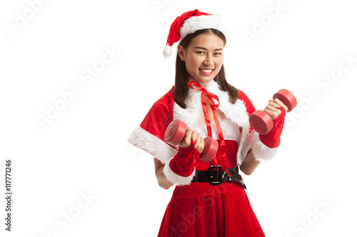 Asian Christmas girl with Santa Claus clothes and red dumbbells.