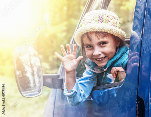 Child in the car at sunset. photo