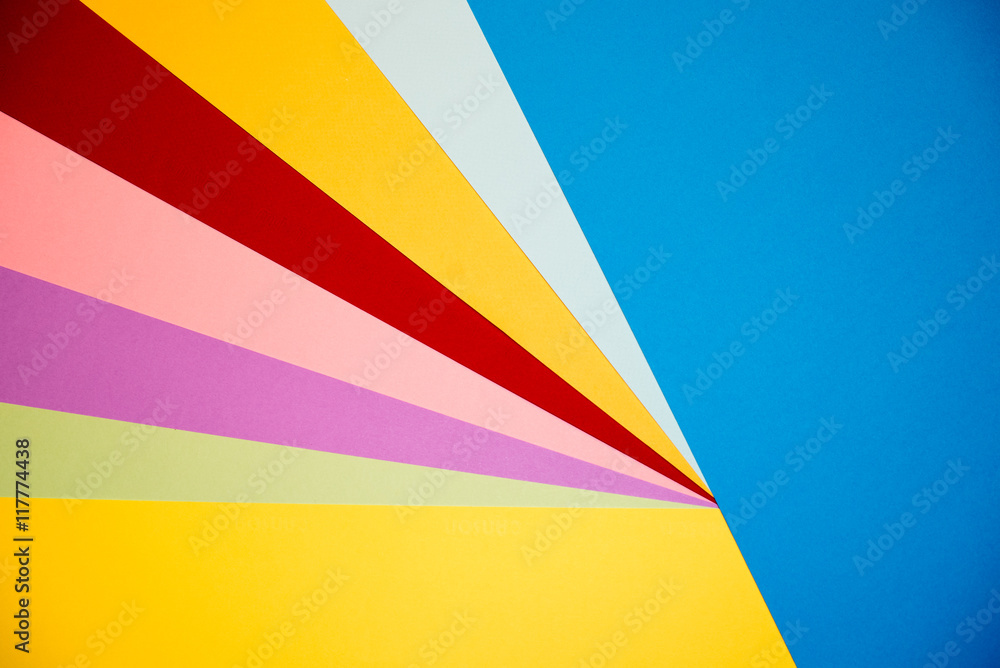 Color papers geometry flat composition background with yellow orange red violet and blue tones