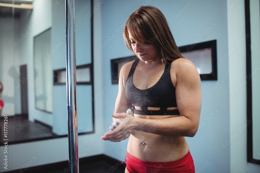 Pole dancer applying powder on hand Pole dancer applying powder on hand