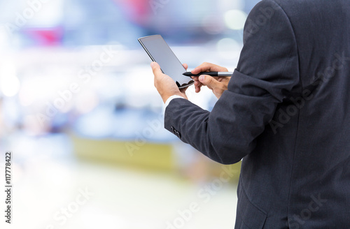 isolated business man hold the smartphone on shopping mall background


