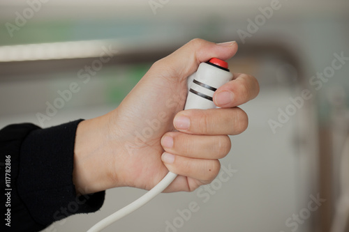 women hand pressing emergency nurse call button photo