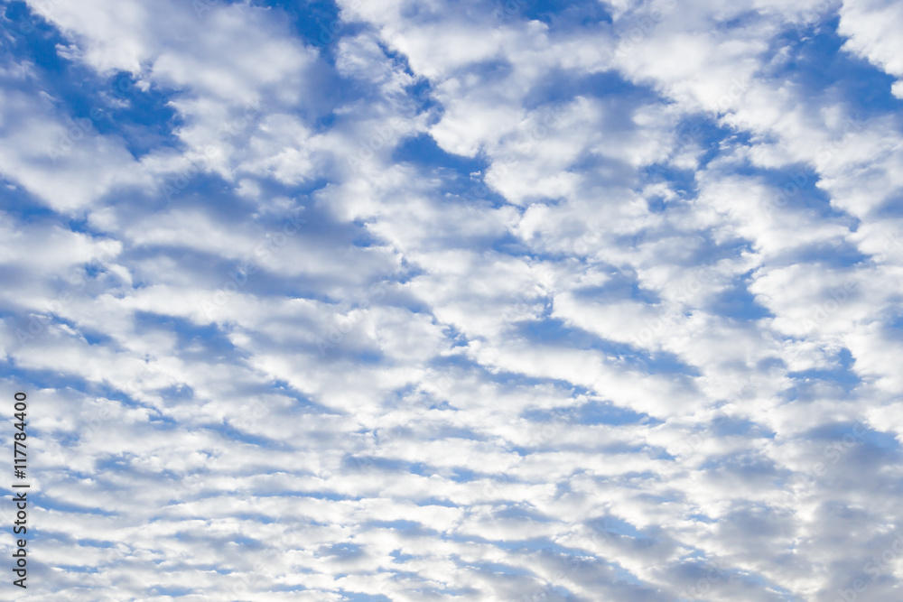White puffy stratus clouds against a deep blue sky. White puffy stratus clouds against a deep blue sky.