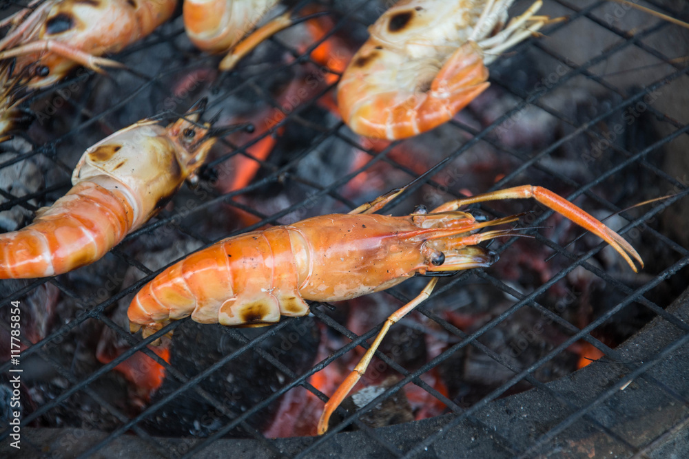 grilled shrimps with flames in background grilled shrimps with flames in background