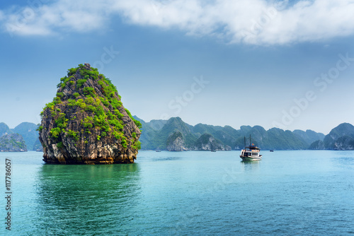 Scenic karst isle and tourist boat in the Ha Long Bay, Vietnam