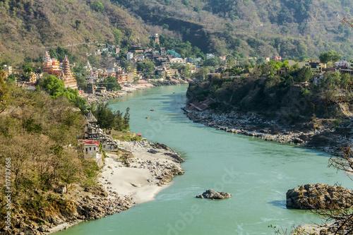 A photo of the Rishikesh Valley from the Lakshman Jhula iron suspension bridge across the River Ganges in the holy city of Rishikesh, North India. photo