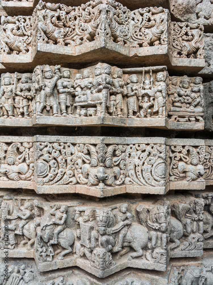 A wall covered in sculpted figures symbolizing different historical events at the 13th Century temple of Somanathapur, Karnataka, South India.