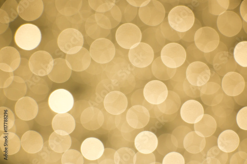 Photo Glowing golden bokeh background for designing purposes