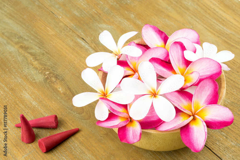 Plumeria in wooden bowl on wooden background Plumeria in wooden bowl on wooden background
