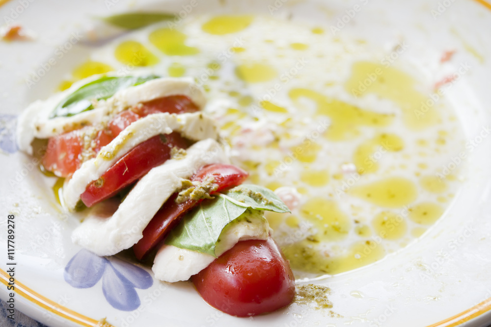 Fresh caprese salad with mozzarella basil and tomatoes Fresh caprese salad with mozzarella basil and tomatoes