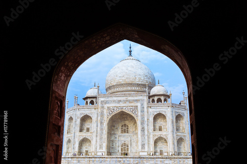 The Taj Mahal seen through a black archway.