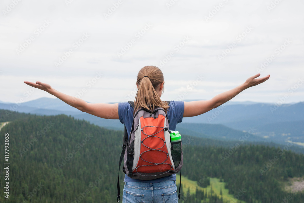 Young woman backpacker at mountain top. Happy and cheering concept Young woman backpacker at mountain top. Happy and cheering concept