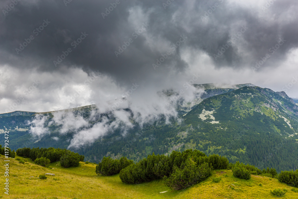 Mountain landscape in the Transylvanian Alps in summer, with mist clouds after the rain