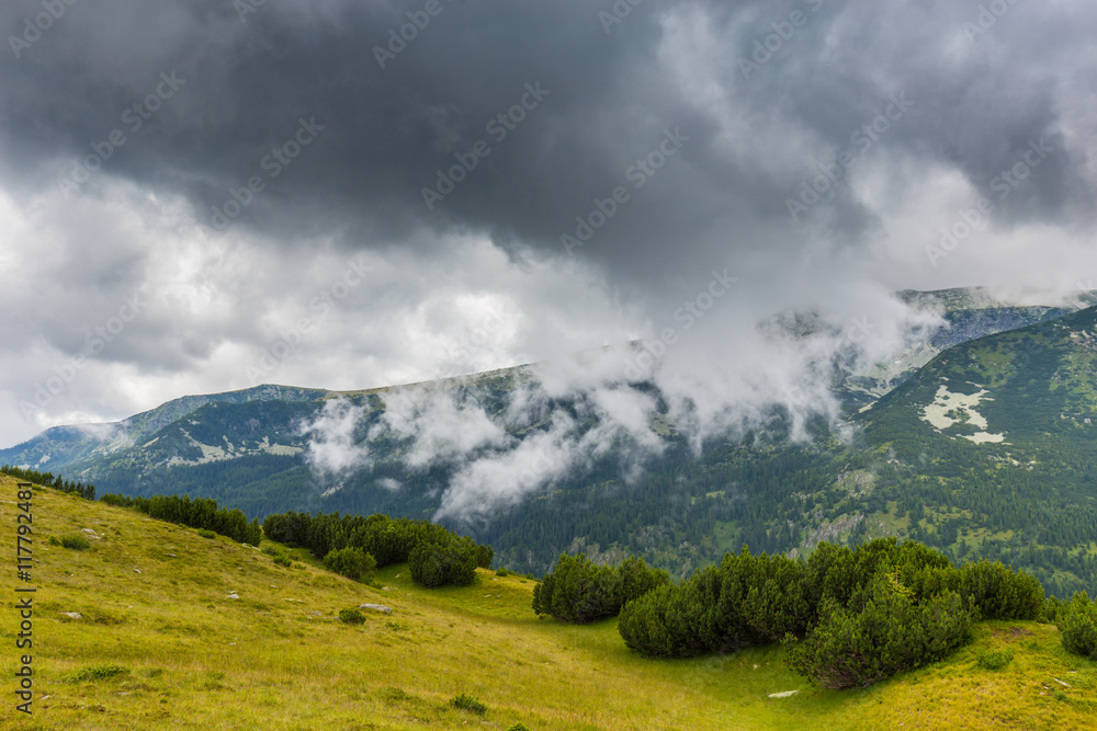 Mountain landscape in the Transylvanian Alps in summer, with mist clouds after the rain