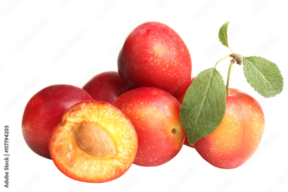 red plums with leaves on white isolated background