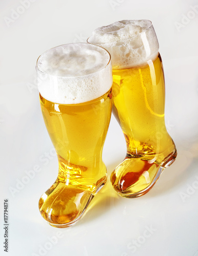 Boot shaped beer glasses filled with frothy lager photo