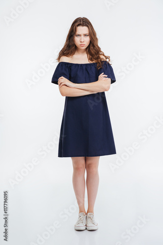 Full length of angry young woman standing with arms crossed © Drobot Dean