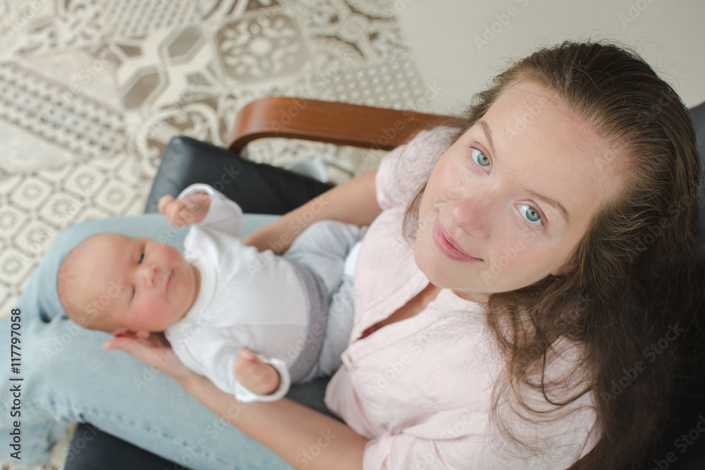 Young mother newborn her lap armchair top view Young mother newborn her lap armchair top view