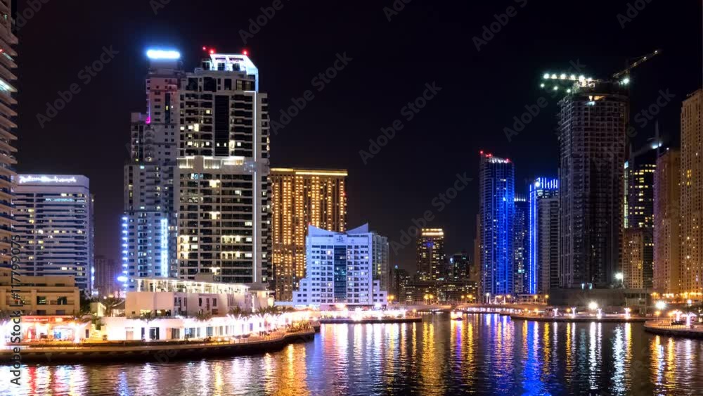Dubai Jumeira Marina life Night view time-lapse video 4k. Skyscrapers modern buildings reflect in water Travel tourism Real Estate business in United Arab Emirates time lapse. Dubai Jumeira Marina life Night view time-lapse video 4k. Skyscrapers modern buildings reflect in water Travel tourism Real Estate business in United Arab Emirates time lapse.