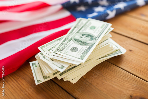 close up of american flag and dollar cash money