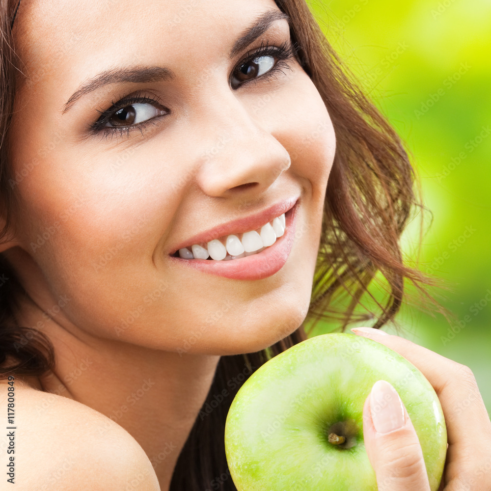 Young happy smiling woman with apple, outdoors Young happy smiling woman with apple, outdoors