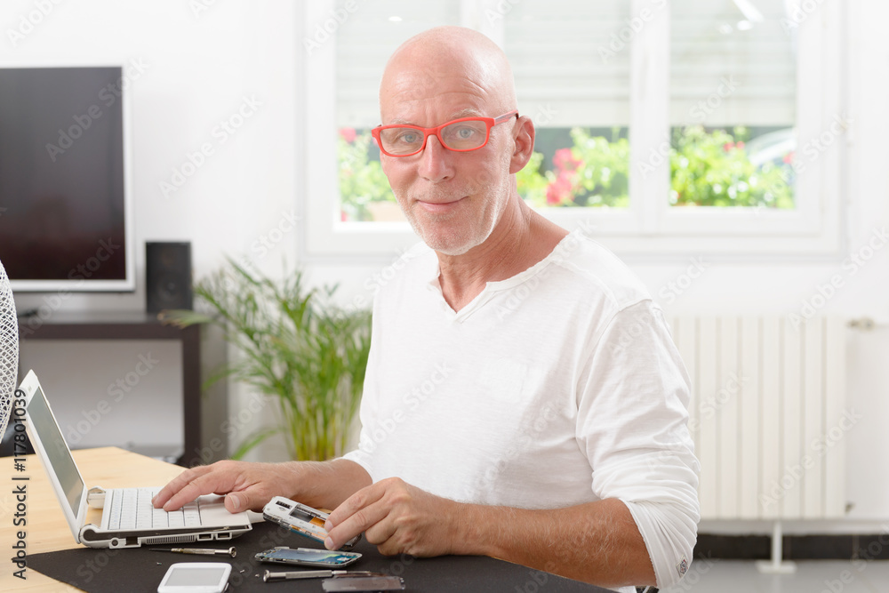 mature man repaired a smartphone mature man repaired a smartphone