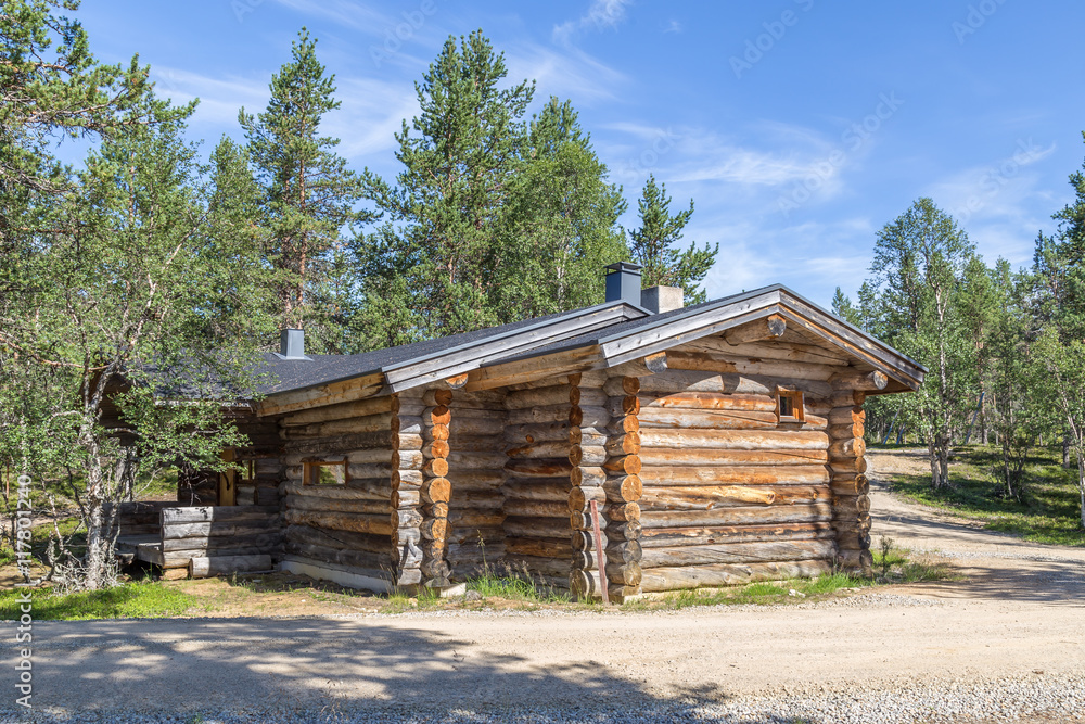 Finnish wooden loghouse in the forest of Lapland Finnish wooden loghouse in the forest of Lapland