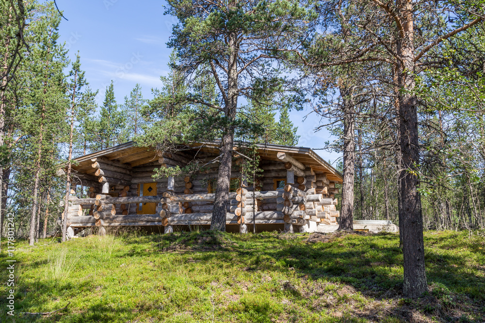 Finnish wooden loghouse in the forest of Lapland Finnish wooden loghouse in the forest of Lapland