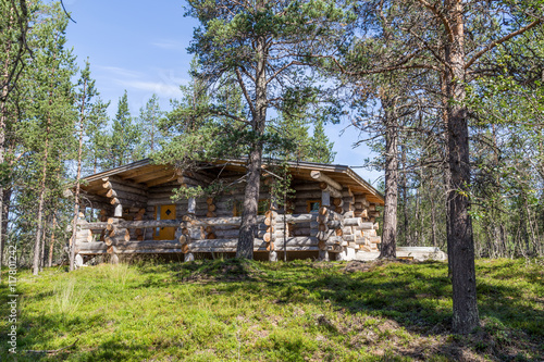 Finnish wooden loghouse in the forest of Lapland photo
