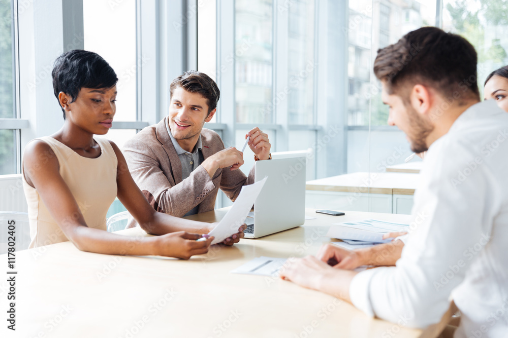 Businesspeople sitting at the table on a meeting Businesspeople sitting at the table on a meeting