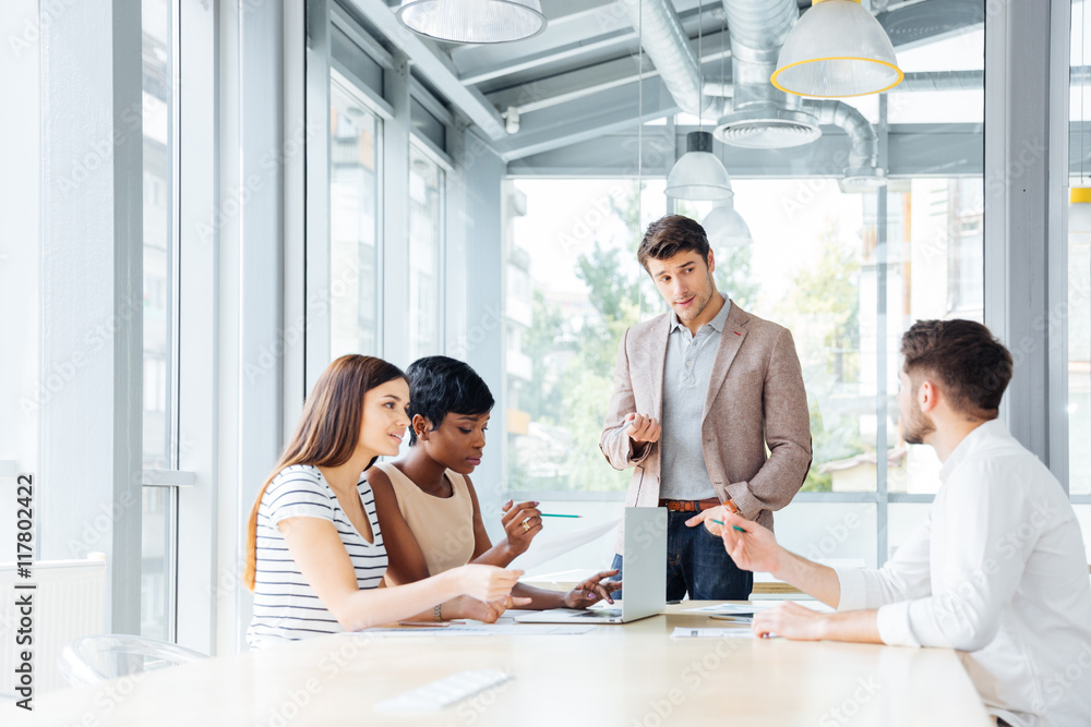 Young businesspeople working and making new project in office together Young businesspeople working and making new project in office together