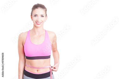 Lady at gym holding tape line around waist © Catalin Pop