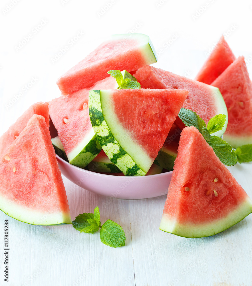 Triangular slices of fresh watermelon on white wooden background Triangular slices of fresh watermelon on white wooden background
