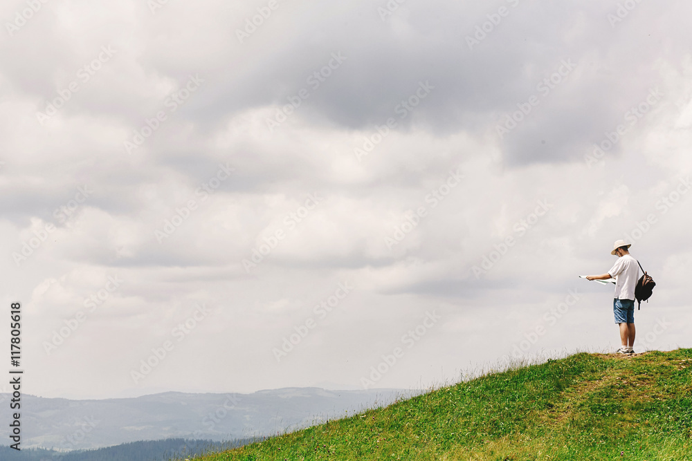 hipster traveler on top of mountains with amazing view and holdi hipster traveler on top of mountains with amazing view and holdi