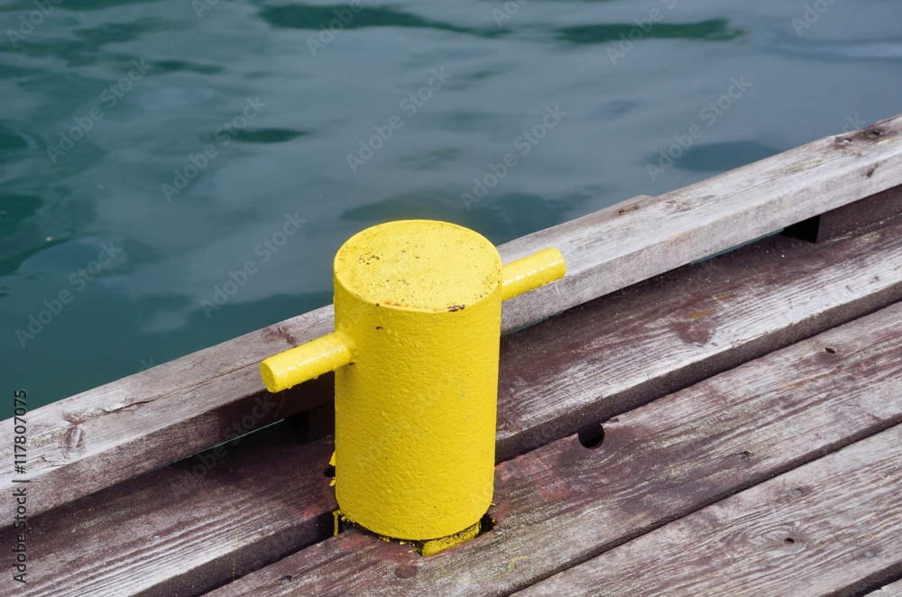 Naklejka premium Yellow post for tying up boat