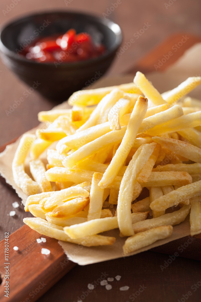 french fries with ketchup over rustic background french fries with ketchup over rustic background