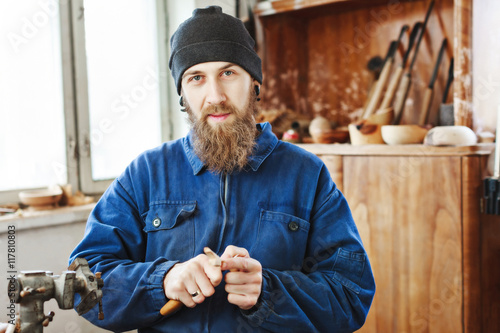 A man working with woodcarving instruments photo