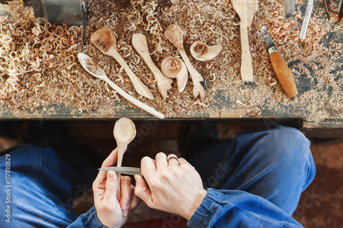 Canvas Print A man working with woodcarving instruments