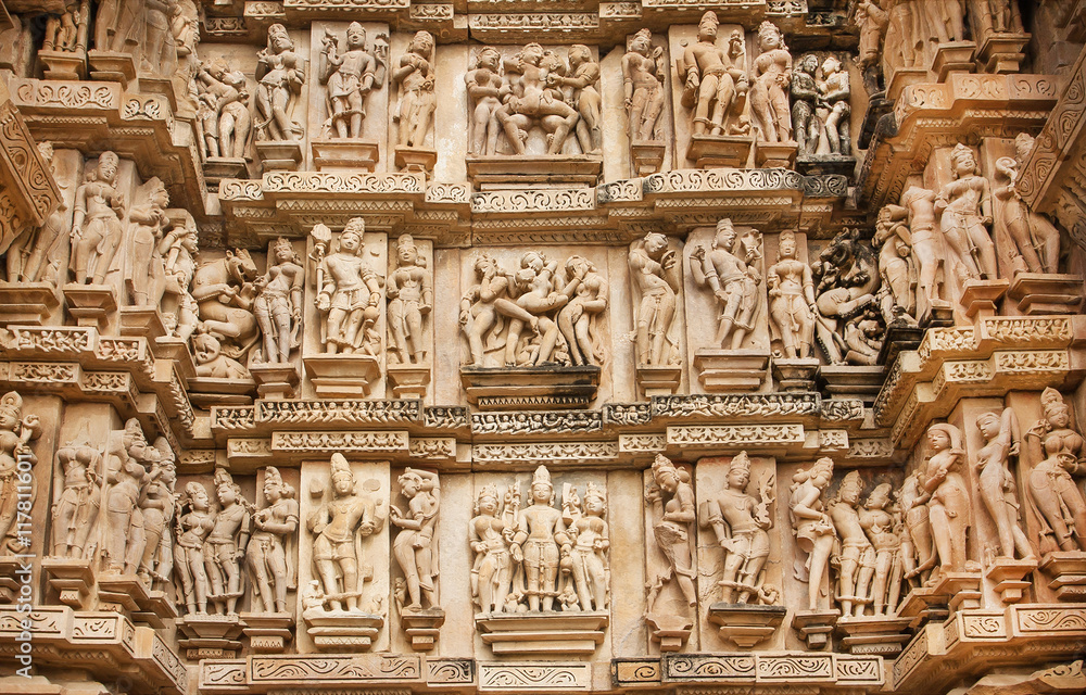 Famous historic monumant with erotic theme on sculptured wall of temple of Khajuraho. Built between 950 - 1150 in India