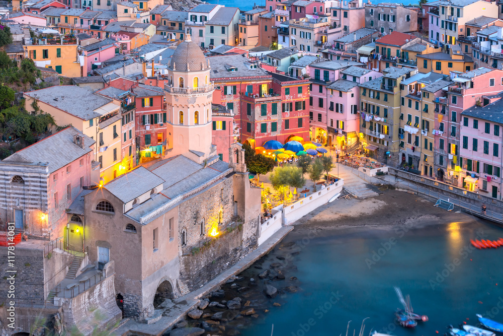 Aerial view of Vernazza fishing village with Santa Margherita di Antiochia Church at sunset, seascape in Five lands, Cinque Terre National Park, Liguria, Italy.
