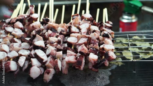 Local street food of Seoul, Korea, Octopus skewer steam and burn cooked before eating photo