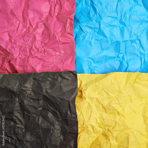Four CMYK colored paper sheets