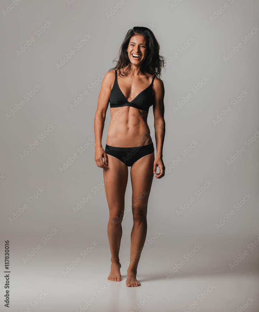 Happy vivacious young woman in black lingerie Happy vivacious young woman in black lingerie