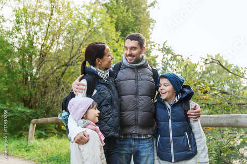 happy family with backpacks hiking