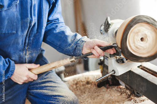 A man working with woodcarving instruments photo