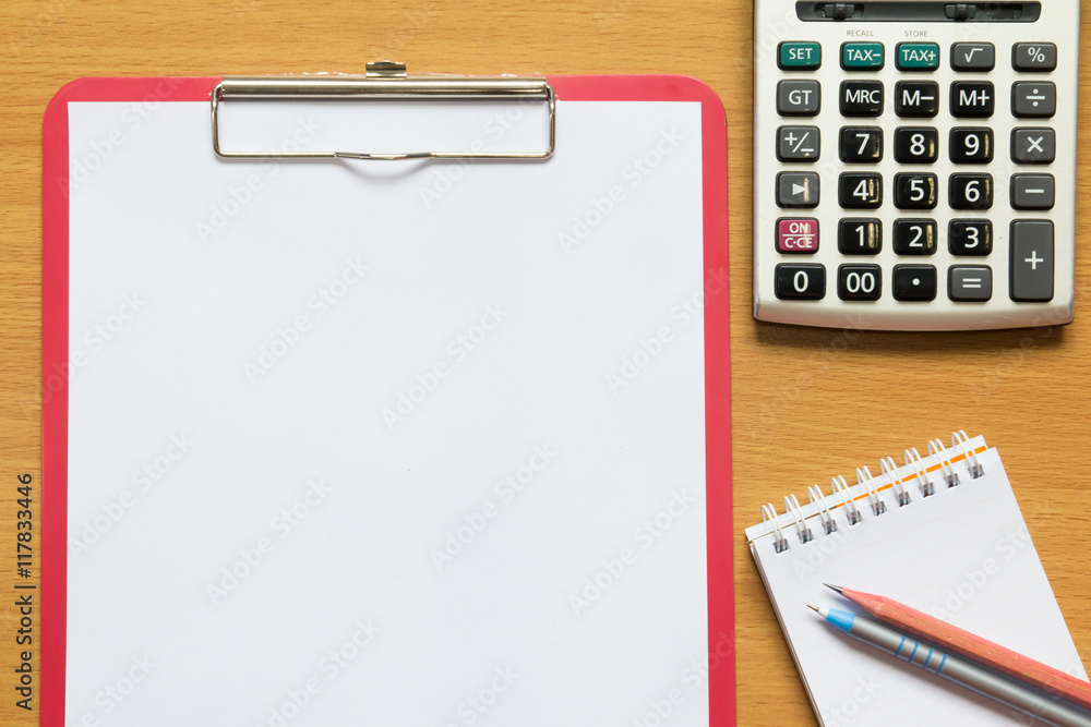 Paper in red file, pencil, pen, calculator and paper note on woo Paper in red file, pencil, pen, calculator and paper note on woo