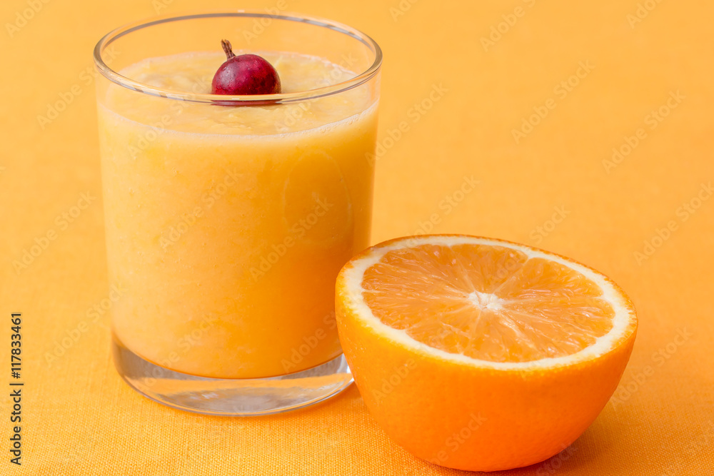 Orange smoothie with gooseberry on orange background Orange smoothie with gooseberry on orange background