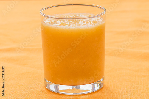 Orange smoothie on orange background
